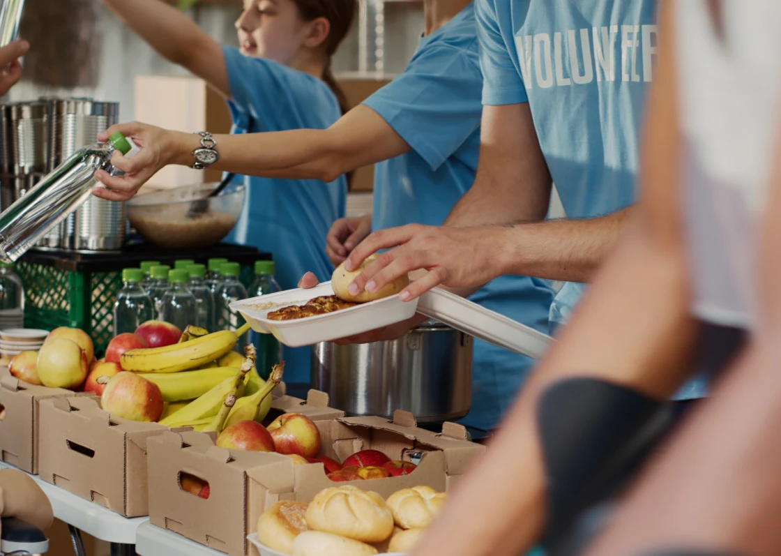 Volunteers serving food at a community event.